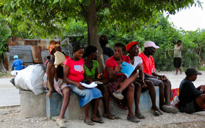 Women reading and learning on the street, Port-Au-Prince, Haiti, 2012.