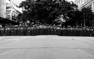 Police  barrier to contain protesters. frightened residents in central region, Belo Horizonte, Brazil, 2014.