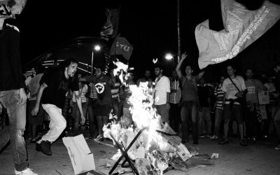 Protester jumping on the burning turnstile , Belo Horizonte, Brazil, 2014.