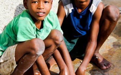 Even in the face of chaos, violence, hunger and poverty, Haitian children do not lose their smiles and the desire to play, even if the toys are limited to the mud, stones or debris of old buildings destroyed by the earthquake. Cité Soleil, Port-Au-Prince, Haiti, 2012.