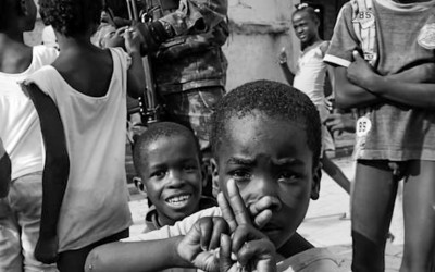 Peacekeeper with children in Cité Soleil, Port-Au-Prince, Haiti, 2012.