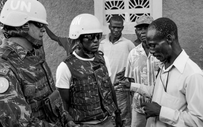Dialogue between resident of Cité Soleil and peacekeeper mediated by local translator, Port-Au-Prince, Haiti, 2012.