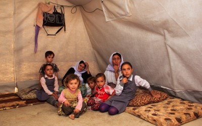In some cases, residents welcome children from the family and from friendly families who lost their parents and caretakers initially legit. There are 9 people in this tent, 7 of them children. Cover II Refugee Camp, near Duhok, Iraq (Iraqi Kurdistan).