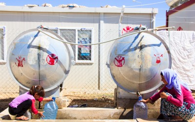 Families enjoy some water stations inside the fields to supply their homes. In summer temperatures can reach 45 degrees. Sharia Refugee Camp, near Duhok, Iraq (Iraqi Kurdistan).