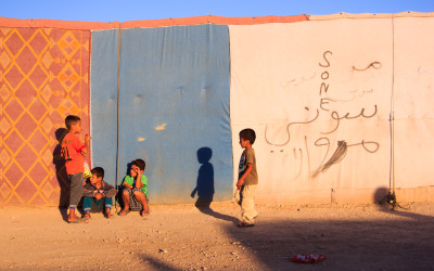 Since there are no schools, children play with remains of tent constructions when they should be learning, Sharia Refugee Camp, Iraq (Iraqi Kurdistan).