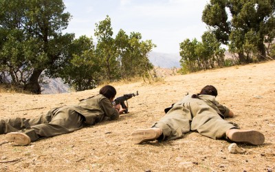 Member of the Kurdish Worker’s Party (PKK) aiming a riffle in one of the frontlines of the guerrilla’s territory in the region. Originally created in Turkey, 1978, to fight against the cultural and political censures and to claim a Nation State, the PKK is also fighting in Iraq since 2014 when the Islamic State (ISIS) invaded the region. Qandil mountains, Iraq (Iraqi Kurdistan), 2015.