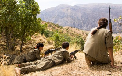 Members of the Kurdish Worker’s Party (PKK) aiming a riffle in one of the frontlines of the guerrilla’s territory in the region. Originally created in Turkey, 1978, to fight against the cultural and political censures and to claim a Nation State, the PKK is also fighting in Iraq since 2014 when the Islamic State (ISIS) invaded the region. Qandil mountains, Iraq (Iraqi Kurdistan), 2015.