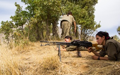 Member of the Kurdish Worker’s Party (PKK) aiming a riffle in one of the frontlines of the guerrilla’s territory in the region. Originally created in Turkey, 1978, to fight against the cultural and political censures and to claim a Nation State, the PKK is also fighting in Iraq since 2014 when the Islamic State (ISIS) invaded the region. Qandil mountains, Iraq (Iraqi Kurdistan), 2015.