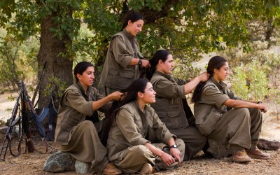 Small group of the Kurdish Worker’s Party (PKK) guerrillas braiding each other’s hairs. After their daily training, and after studying politics and philosophy and manufacturing their own food, the PKK women perform a rite based in strengthening their ties, relaxation and humility. Qandil mountains, Iraq (Iraqi Kurdistan), 2015.