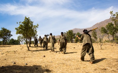 Kurdish Worker’s Party (PKK) member fires at the sky during the daily training, as a drone of unknown origin flies over. She confides “As women our objective is not only to fight for a own State but also for a liberation from mentalities and thoughts.  War is not only for territory or nation. It is, inclusively, not to let the patriarchal system prevail. In the guerrilla we find out we are all capable.”  Qandil mountains, Iraq (Iraqi Kurdistan), 2015.