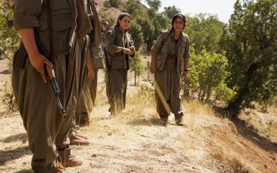 Kurdish Worker’s Party (PKK) member fires at the sky during the daily training, as a drone of unknown origin flies over. She confides “As women our objective is not only to fight for a own State but also for a liberation from mentalities and thoughts.  War is not only for territory or nation. It is, inclusively, not to let the patriarchal system prevail. In the guerrilla we find out we are all capable.”  Qandil mountains, Iraq (Iraqi Kurdistan), 2015.