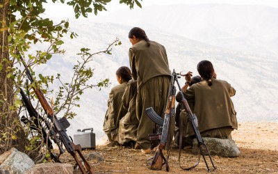 Small group of the Kurdish Worker’s Party (PKK) guerrillas braiding each other’s hairs. After their daily training, and after studying politics and philosophy and manufacturing their own food, the PKK women perform a rite based in strengthening their ties, relaxation and humility. Qandil mountains, Iraq (Iraqi Kurdistan), 2015. -992