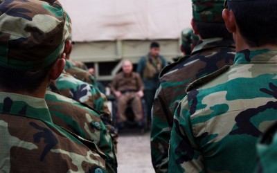 General of the Peshmerga command passes instructions to the soldiers in the next hours of combat against the Islamic state. After being shot in conflict, the general, who is in a wheelchair, no longer fights. Iraq (Iraqi Kurdistan), Middle East, 2015.